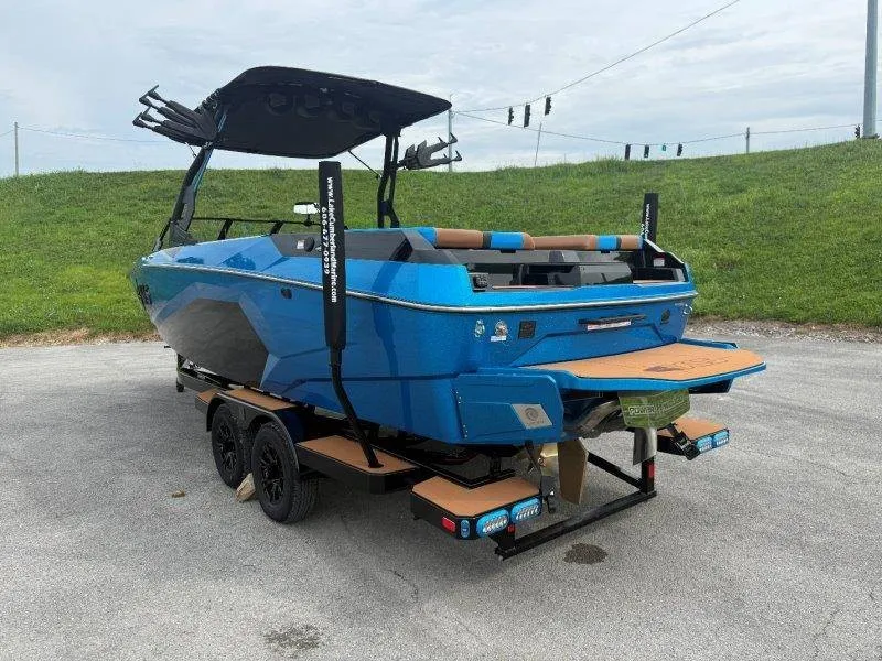 Slide: The Image of A 2027 Axis A245 boat with a blue hull and modern design on a trailer. - 22