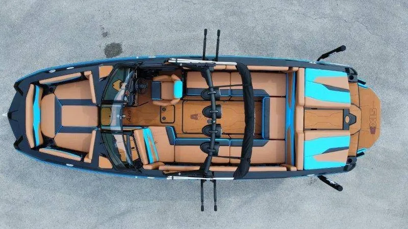 Slide: The Image of The image shows a 2027 Axis A245 boat with brown and blue upholstery and a modern design. - 8