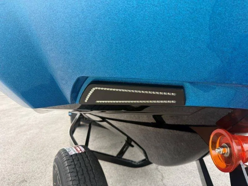 Slide: The Image of A blue Axis A245 boat hull with LED lights and a trailer underneath. - 23