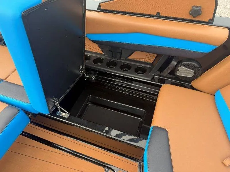Slide: The Image of The image shows the interior of a 2027 Axis A245 boat with blue and brown seating. - 34