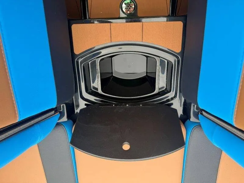 Slide: The Image of The image shows the interior of an Axis A245 boat with blue and brown upholstery. - 47