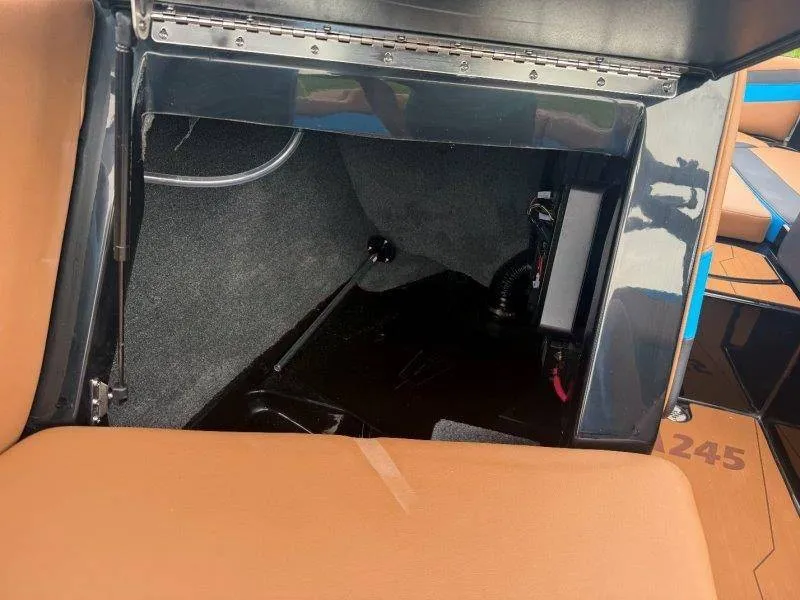 Slide: The Image of A view into the storage compartment of a 2027 Axis A245 boat with brown upholstery. - 35