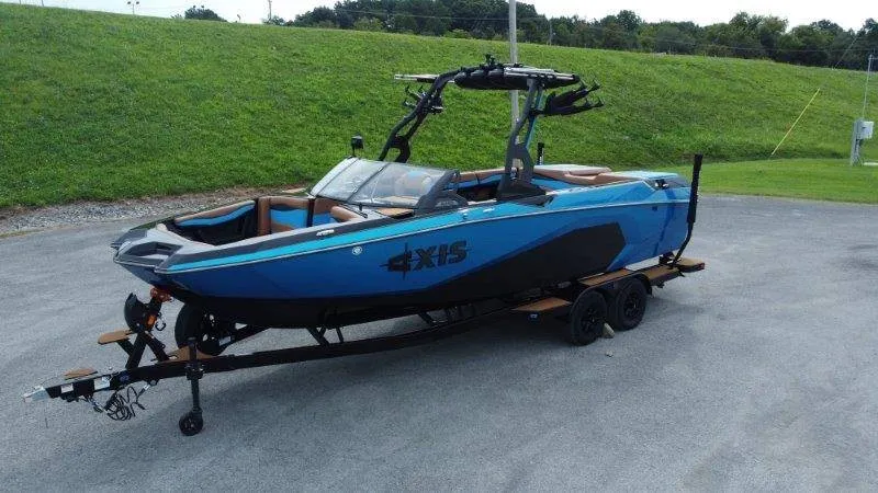 Slide: The Image of A 2027 Axis A245 boat on a trailer in a parking area. - 2