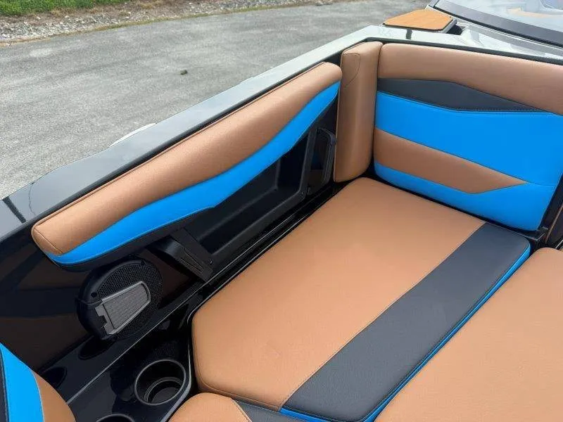 Slide: The Image of The 2027 Axis A245 interior features brown and blue upholstery with speakers and cup holders. - 46