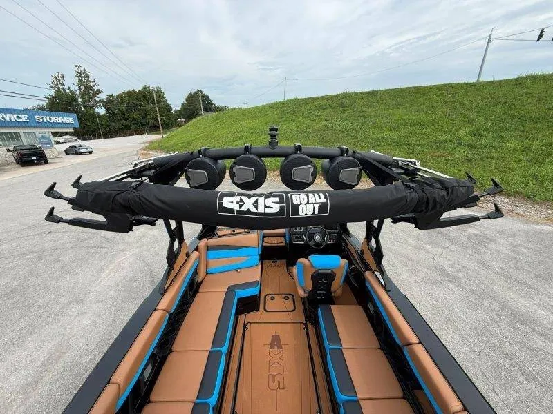 Slide: The Image of The image shows a 2027 Axis A245 boat with brown and blue seating. - 50