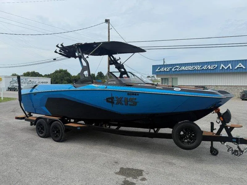 Slide: The Image of A blue 2027 Axis A245 boat on a trailer in front of a building. - 15