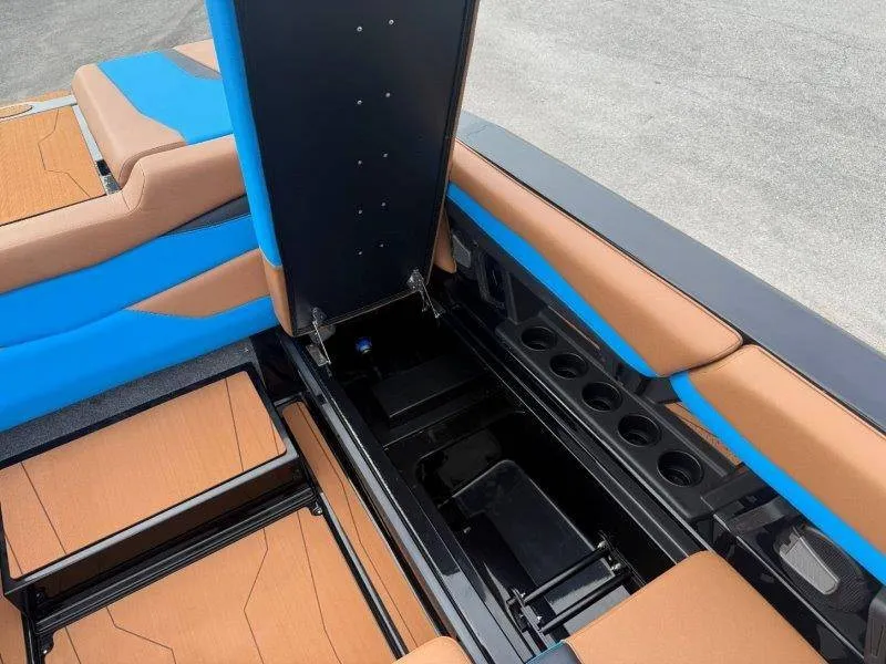Slide: The Image of The image shows the interior of a 2027 Axis A245 boat with blue and brown upholstery. - 29