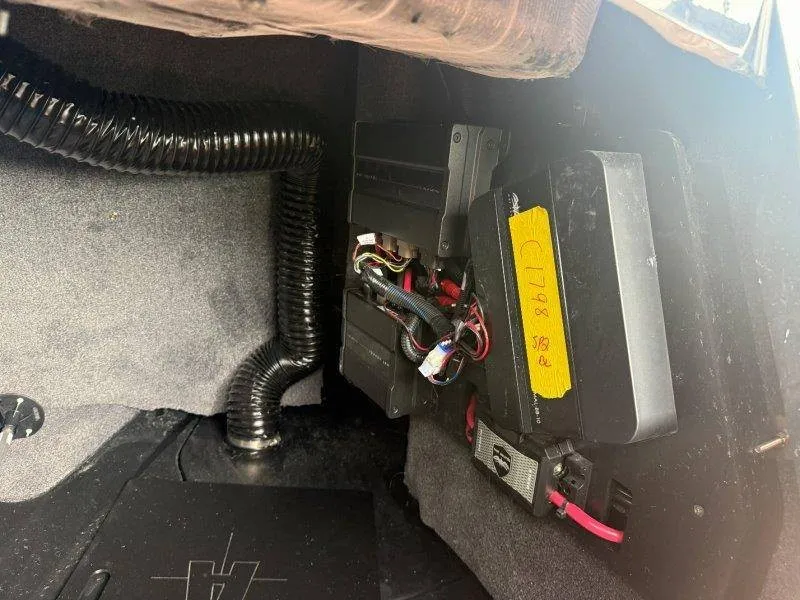 Slide: The Image of An electrical system with wires and components in a boat, surrounded by gray carpeting. - 39