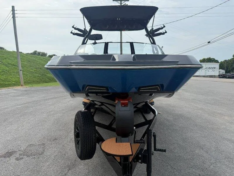 Slide: The Image of A 2027 Axis A245 boat is on a trailer in a parking lot. - 24