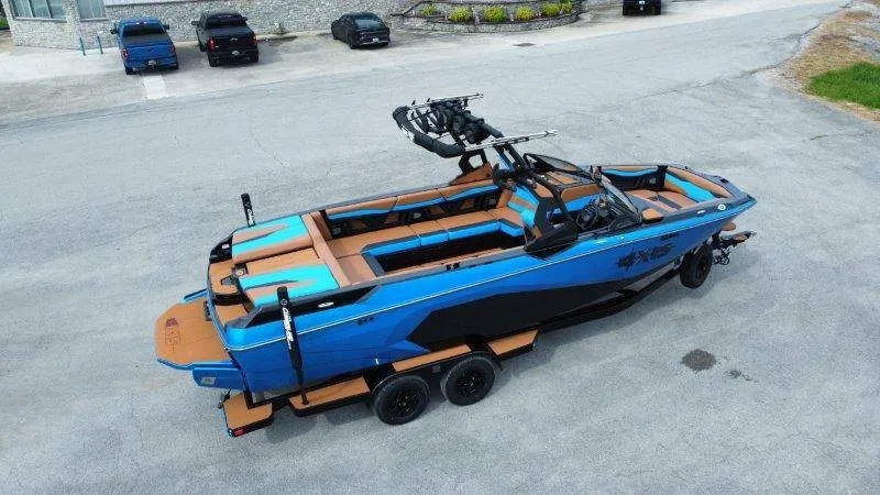 Slide: The Image of A blue Axis A245 boat from 2027 is on a trailer in a parking lot. - 7