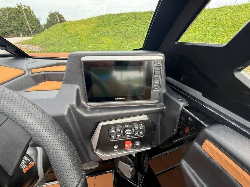 Slide: The Image of The image shows the cockpit of an Axis A245 boat with a Garmin display and controls. - 48