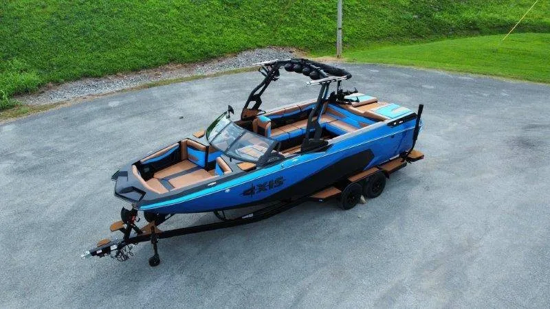 The Image of Axis A245 2027: Sleek design with blue and black paint, sitting on a trailer. - 1