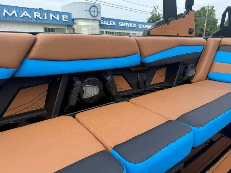Slide: The Image of The 2027 Axis A245 interior features brown and blue upholstery with built-in speakers. - 44