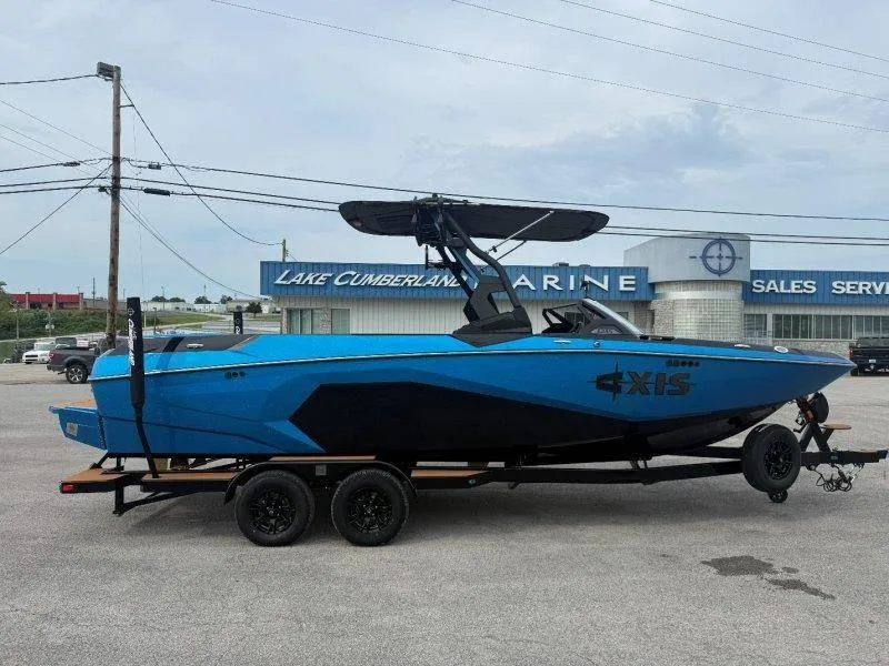 Slide: The Image of A blue 2027 Axis A245 boat on a trailer in front of a marine store. - 13