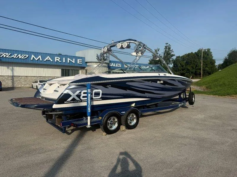 Slide: The Image of A 2006 MasterCraft X-80 boat on a trailer in front of a building labeled "Marine." - 14