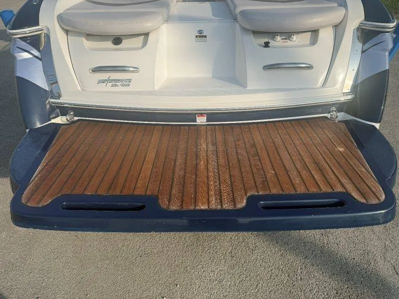 Slide: The Image of The image shows the rear of a 2006 MasterCraft X-80 with a wooden platform. - 46