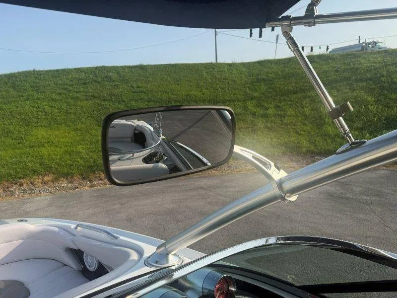 Slide: The Image of A rearview mirror on a 2006 MasterCraft X-80 boat, with a green background. - 28