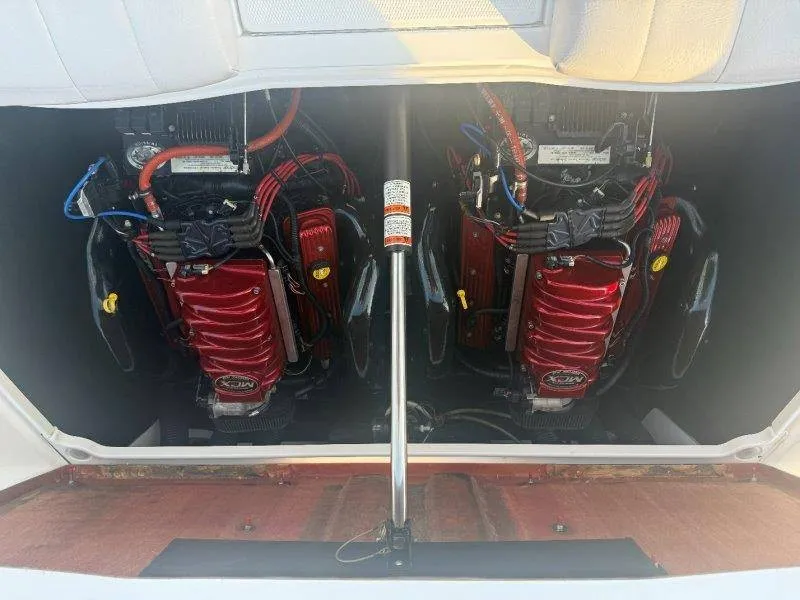 Slide: The Image of The engine compartment of a 2006 MasterCraft X-80 features two powerful engines with red covers. - 33
