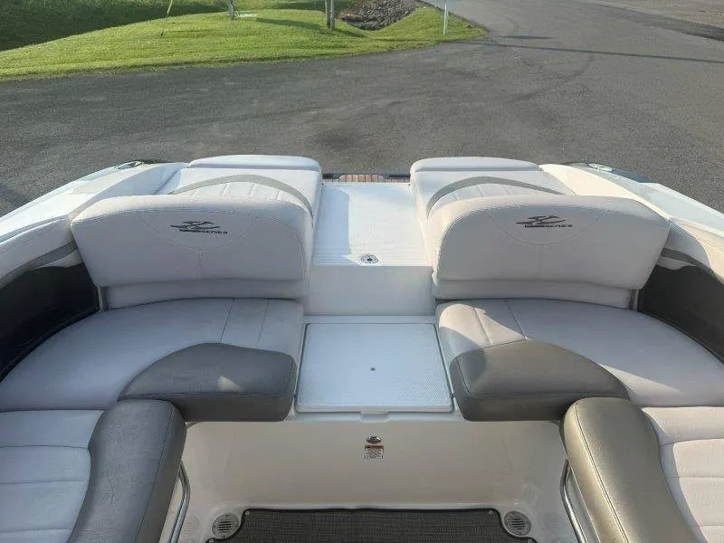 Slide: The Image of The image shows the stern of a 2006 MasterCraft X-80 boat with cushioned seating. - 49