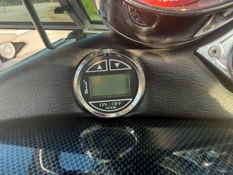 Slide: The Image of Close-up of a control panel with a digital display and buttons in a MasterCraft X-80 boat. - 47