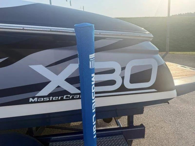 Slide: The Image of The image shows the rear of a 2006 MasterCraft X-80 boat. - 42