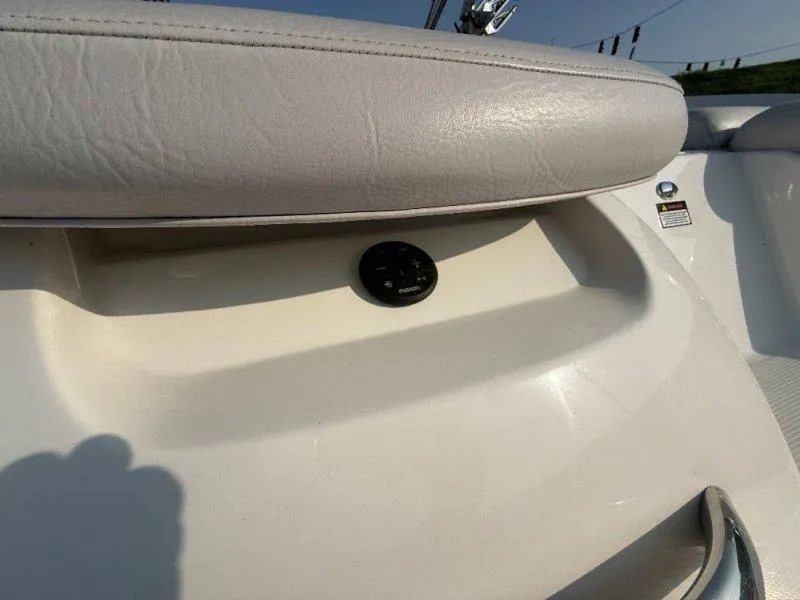 Slide: The Image of Close-up of a white boat seat with a black button underneath. - 20