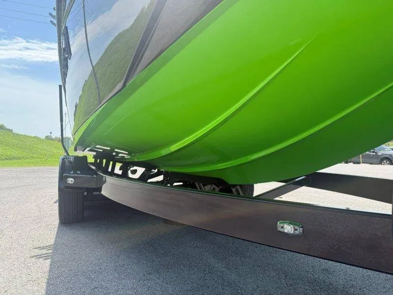 Slide: The Image of A green boat on a trailer, ready for transport. - 10
