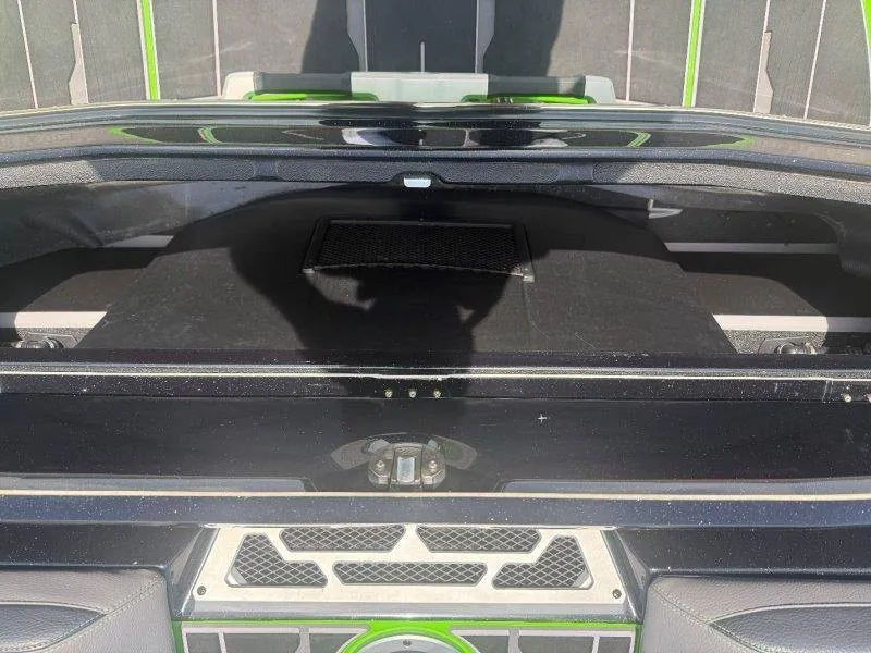 Slide: The Image of The image shows the rear storage area of a 2023 Supra SE 550 boat with green and black accents. - 36