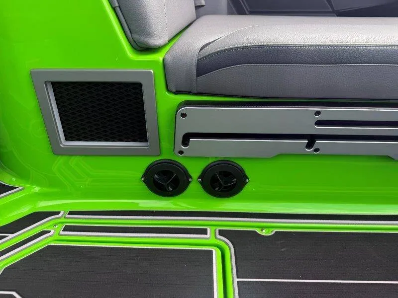 Slide: The Image of Green interior of a Supra SE 550 boat with gray seating and black details. - 48