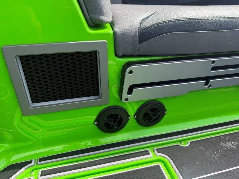 Slide: The Image of Close-up of a green boat deck with speakers and gray upholstery. - 39
