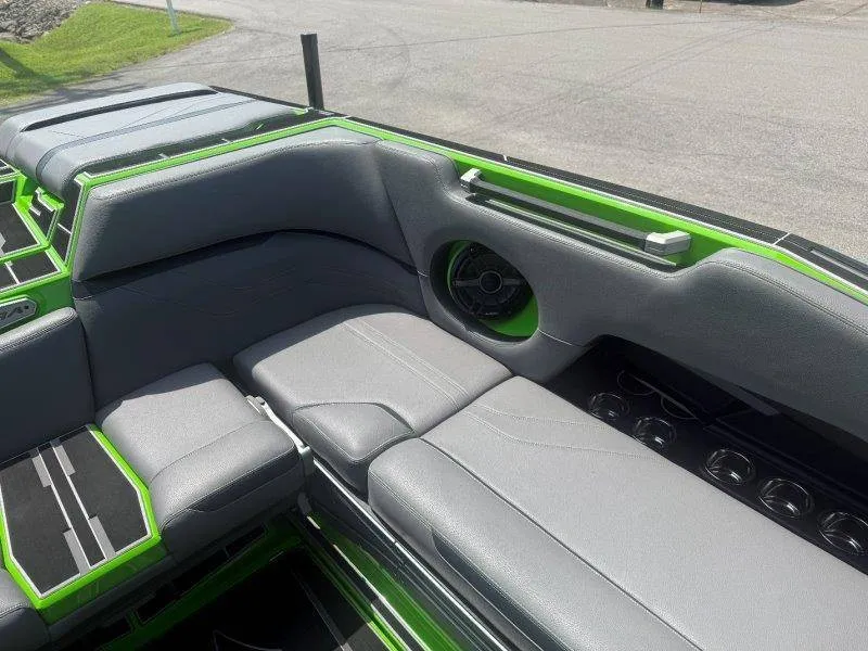 Slide: The Image of The image shows the gray and green interior of a 2023 Supra SE 550 boat. - 41