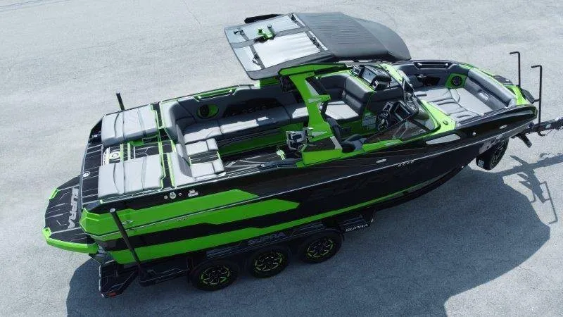 Slide: The Image of 2023 Supra SE 550: A stylish motorboat with green and black design, spacious deck, and modern cockpit. - 4