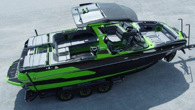 Slide: The Image of A modern green and black 2023 Supra SE 550 boat with spacious deck and seating. - 3