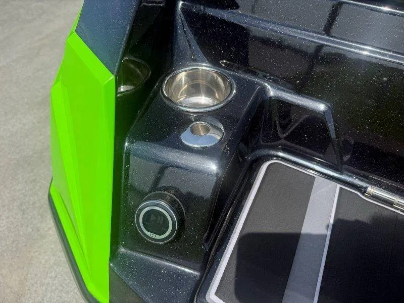 Slide: The Image of Close-up of a green and black boat section with cup holders and a connector. - 43