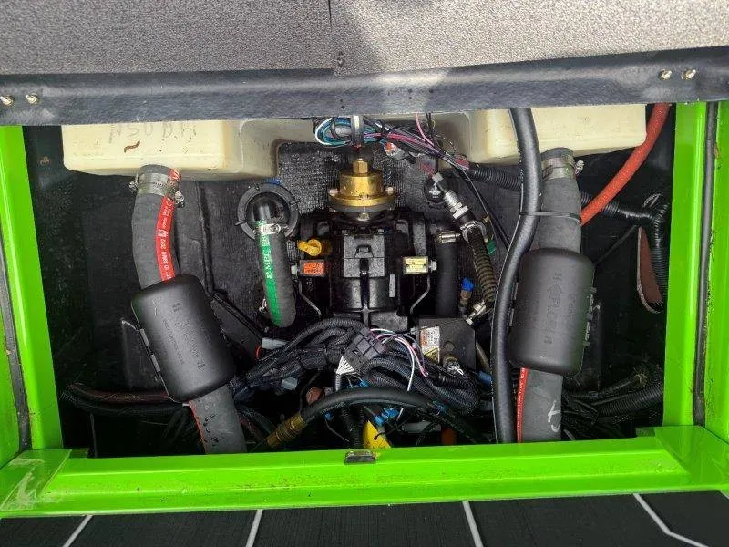 Slide: The Image of Engine compartment of a 2023 Supra SE 550 with visible hoses and wiring. - 45