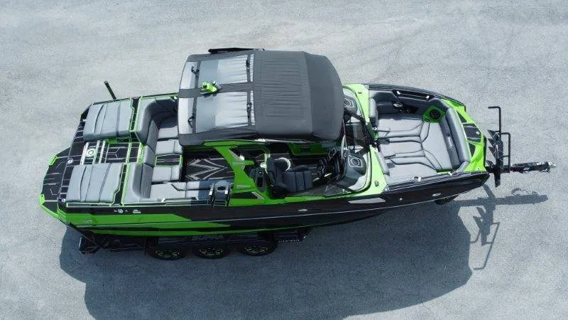 Slide: The Image of The image shows a modern boat, the 2023 Supra SE 550, featuring a green and black design. - 8