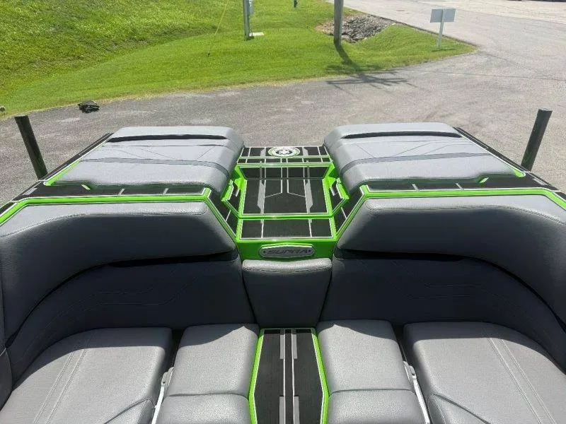 Slide: The Image of The image shows the rear of a Supra SE 550 boat with gray and green upholstery. - 47