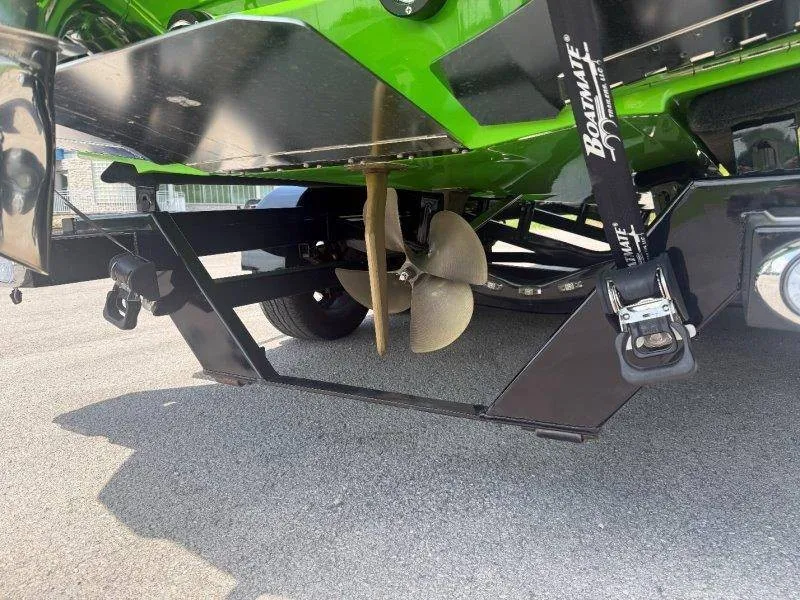Slide: The Image of Close-up of the propeller and stern of a green Supra SE 550 boat. - 20