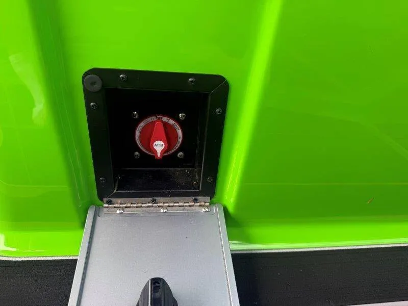 Slide: The Image of A green boat with a black compartment containing a red switch. - 49