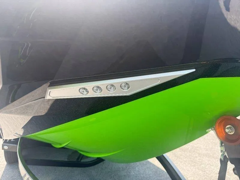 Slide: The Image of Close-up of a green hull on a Supra SE 550 boat with modern design elements. - 11