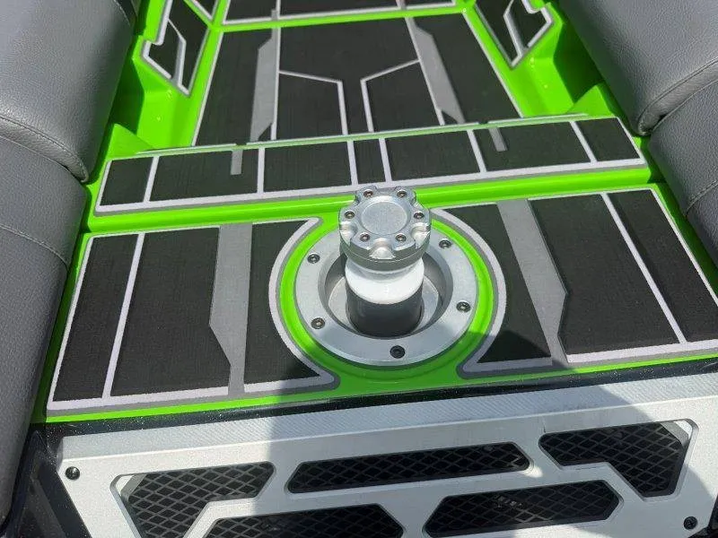 Slide: The Image of The image shows the interior of a Supra SE 550 boat with green and black flooring. - 35