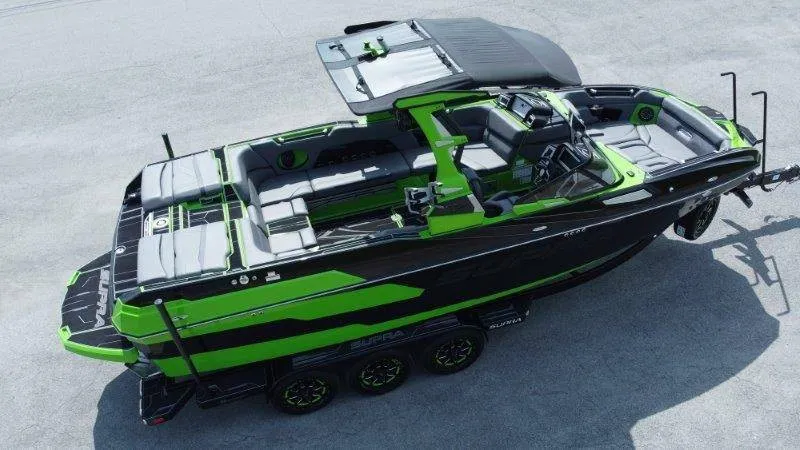 Slide: The Image of The image shows a modern black and green motorboat with luxurious interior and multiple seating areas. - 14