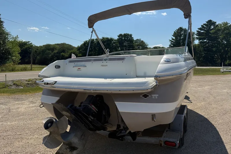 Slide: The Image of 2003 Cobalt 246 boat on trailer, rear view with canopy, parked outdoors. - 3