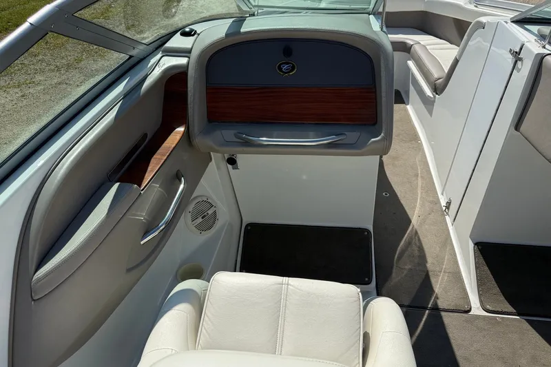 Slide: The Image of Interior of a 2003 Cobalt 246 boat, featuring white seating and wood accents. - 9