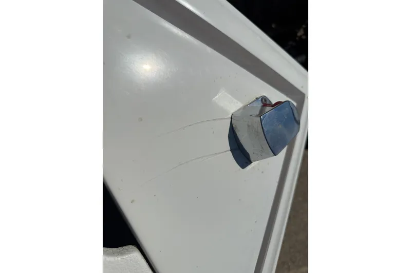 Slide: The Image of Chrome fixture on white surface of 2003 Cobalt 246 boat. - 15