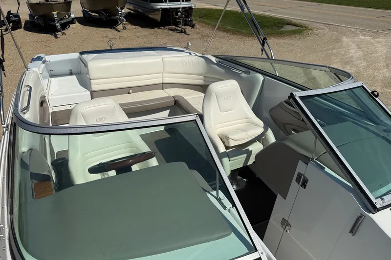 Slide: The Image of 2003 Cobalt 246 boat interior with white seating and steering wheel. - 6