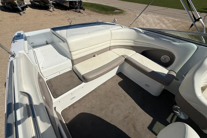 Slide: The Image of Interior of a 2003 Cobalt 246 boat with white and beige seating. - 11