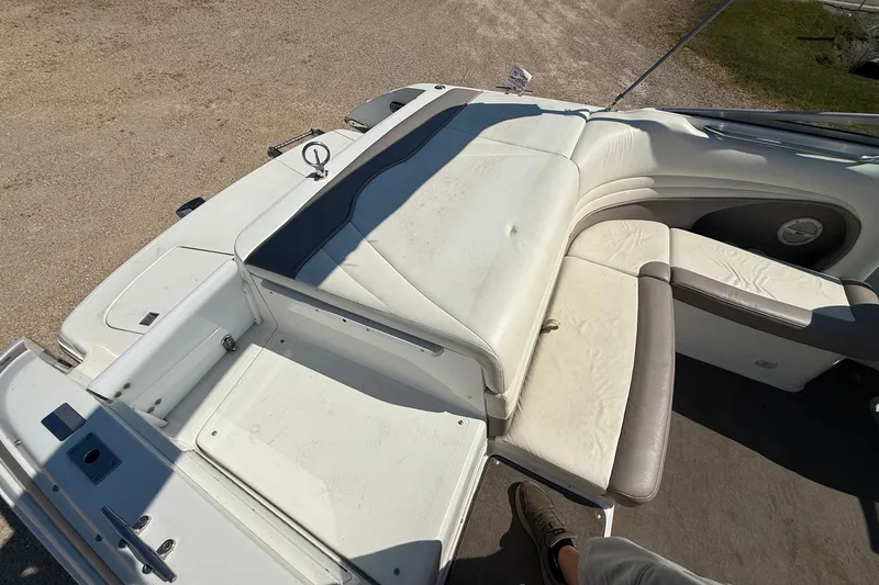 Slide: The Image of 2003 Cobalt 246 boat interior with white leather seating and deck view. - 13