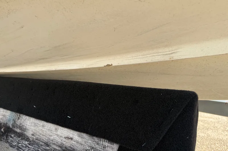 Slide: The Image of Close-up of a 2003 Cobalt 246 boat hull with visible wear and damage. - 17