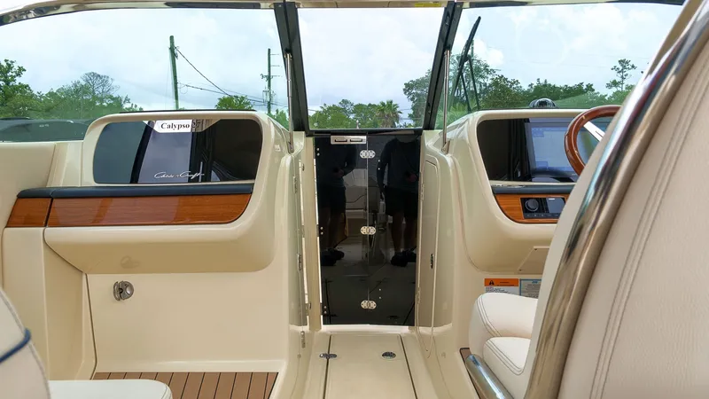 Slide: The Image of The image shows the cockpit of a 2022 Chris-Craft Calypso 27 with elegant wood accents. - 18